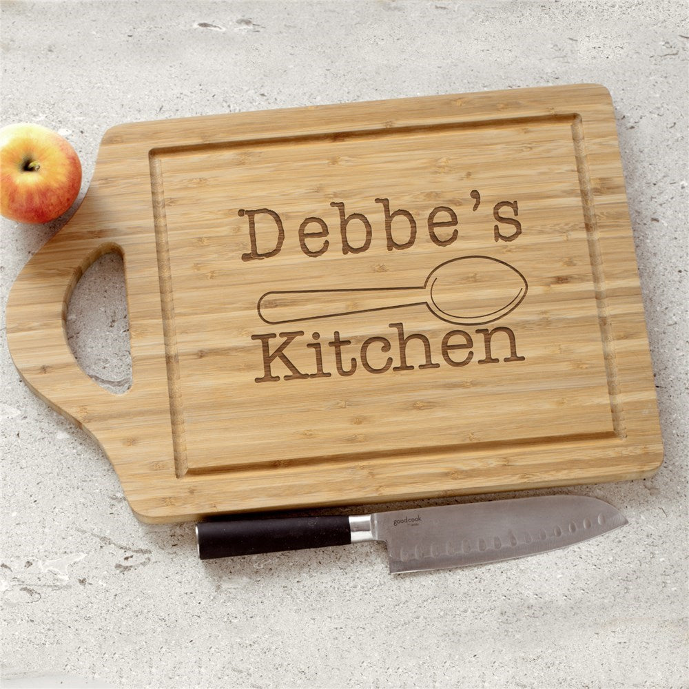Personalized bamboo cutting board engraved with a custom kitchen name